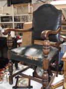 An early 20th century oak carver chair with green leather seat