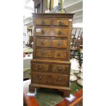 A small mahogany chest on chest.