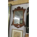 A mahogany framed wall mirror.