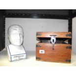 A phrenology head and a wooden box.