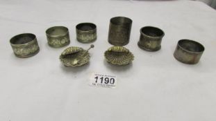 A pair of silver plate shell shaped salts and 6 napkin rings.