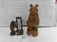 A carved bear thermometer and another carved bear,