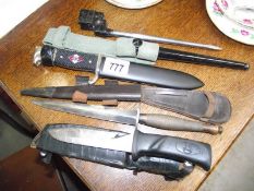 A vintage military dagger, a 303 bayonet, a replica German dagger and a knife.