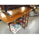 A teak drop leaf dining table.