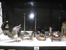 A shelf of assorted metalware including Austrian spelter deer, Indian brassware,