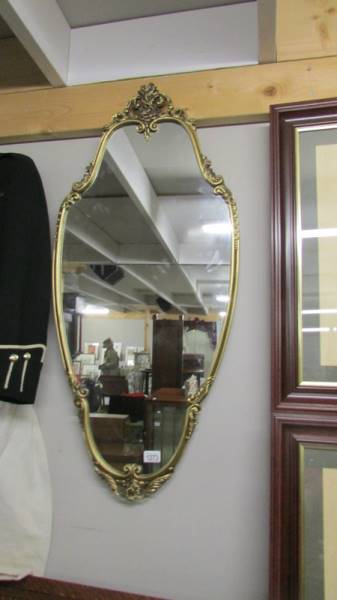 A gilt framed mirror.