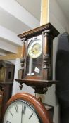 A small mahogany wall clock.