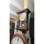 A small mahogany wall clock.