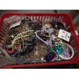 A basket of vintage and retro costume jewellery.