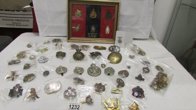 A good collection of military badges including a framed and glazed set.
