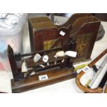 A vintage pipe rack with pipe and a magazine rack.