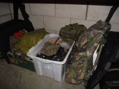 A large collection of military items including backpacks, clothing etc.