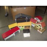 A quantity of wooden and plastic buildings.