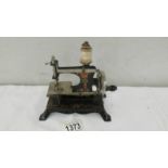 A 19th century miniature sewing machine marked foreign.