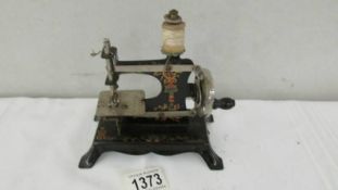 A 19th century miniature sewing machine marked foreign.