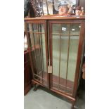 A mahogany display cabinet (missing shelves).