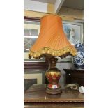 An oriental style table lamp with shade.