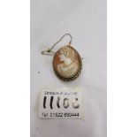 A good quality shell cameo brooch of female profile with safety chain.