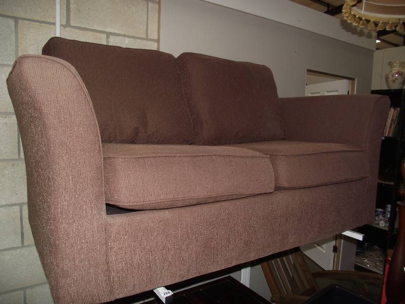 A brown fabric 2 seat sofa.