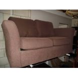 A brown fabric 2 seat sofa.