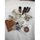 A box of militaria including badges, shell cases, buttons etc.