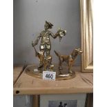 A brass figure with dog