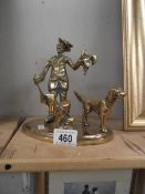 A brass figure with dog