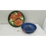 A Walter Moorcroft signed hibiscus plate and a blue hibiscus bowl, circa 1970's.