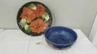 A Walter Moorcroft signed hibiscus plate and a blue hibiscus bowl, circa 1970's.