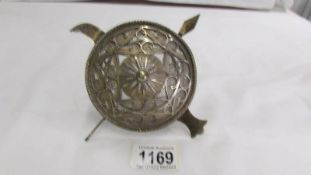 A Japanese ornament of shield with knives, possibly silver.