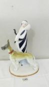 An art deco style figure of a lady with a great dane dog.