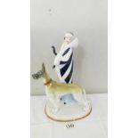 An art deco style figure of a lady with a great dane dog.