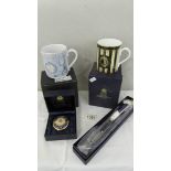 A boxed Royal Worcester 250th anniversary mug, a boxed Millennium mug,