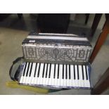 A cased Maseratic accordion.