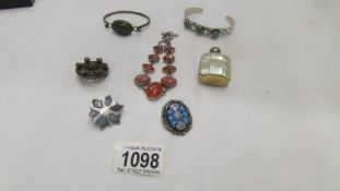 A mother of pearl scent bottles, a hall marked silver bangle, a millifiori brooch,