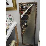 A long gilt framed mirror