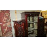 An ornate ebonised display cabinet.