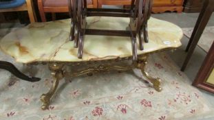 A brass based marble effect coffee table.