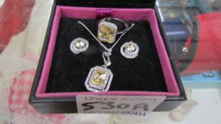 A silver set comprising citreon set ring, pendant and earrings.