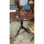 A mahogany inlaid tripod table.