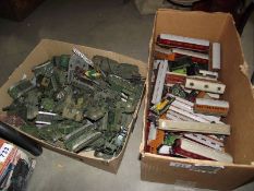 2 boxes of plastic military vehicles and Triang '00' gauge rolling stock, mostly over painted.