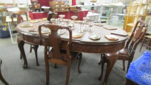 An oval mahogany extending dining table and 4 chairs.
