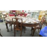 An oval mahogany extending dining table and 4 chairs.