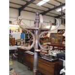 A dark wood stained coat stand.