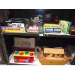 2 shelves of old games including wooden Noah's ark.