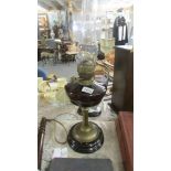 A Victorian brass column oil lamp with glass font.