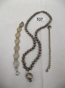 A George V silver threepenny bit bracelet, a necklace and another bracelet.