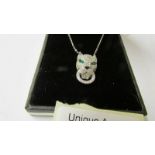 A silver adn CZ Cartier style panther pendant necklace with emerald cultured eyes.