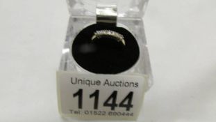 A band ring set with seven diamonds quarter carat total in gold shank, size K.