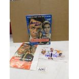An autographed photo of George Lazenby (007), and an autographed DVD by Alexandra Beastedo.